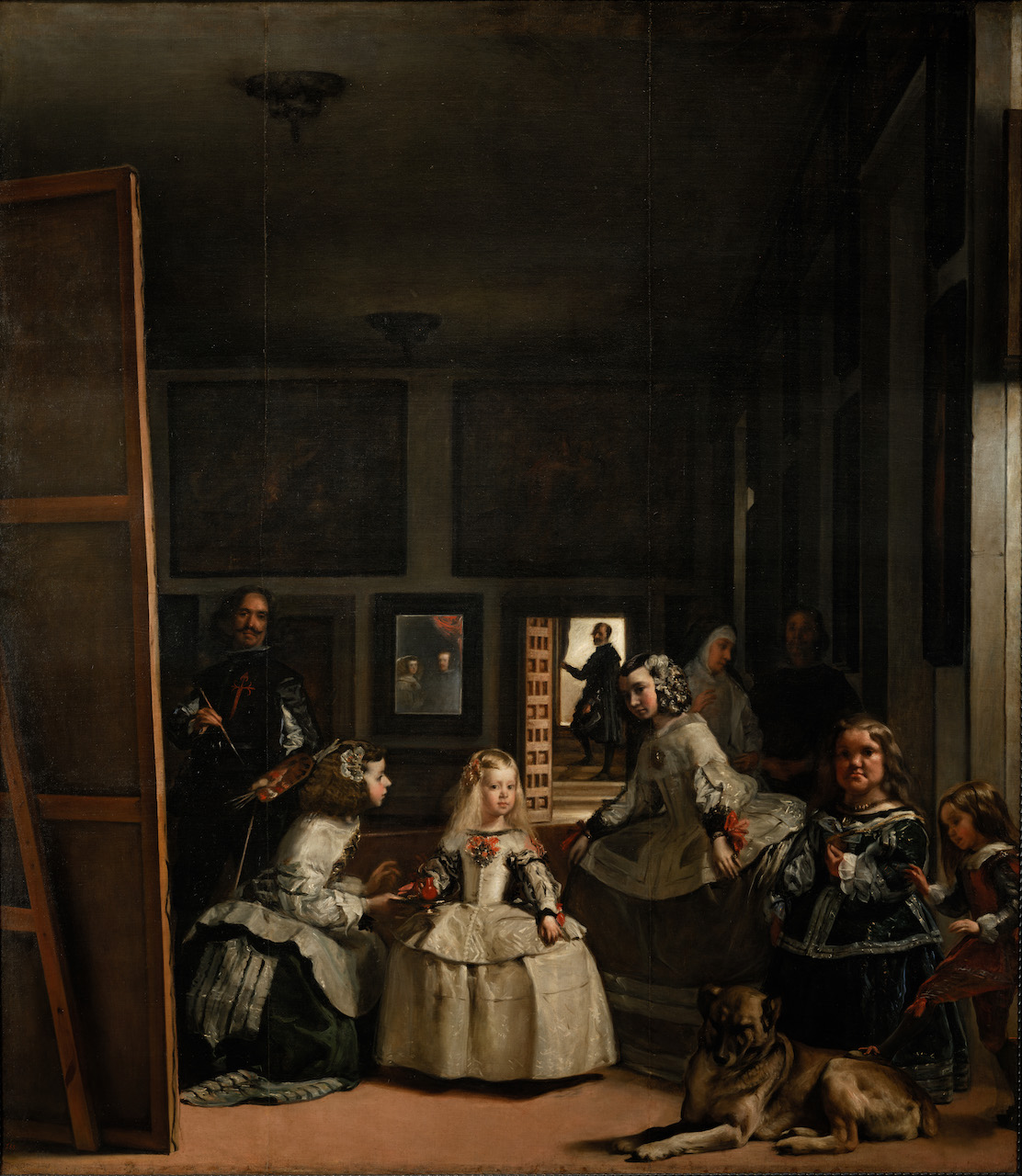 Image 3 Las Meninas by Diego Velazquez A young girl poses for a portrait, attended by her maids. She has pale hair and is in a white dress, with flowers at breast and wrist. Several other adult figures gaze out of the painting, at the viewer.