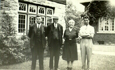 Family of 4 (the Macdonals) posing outside.