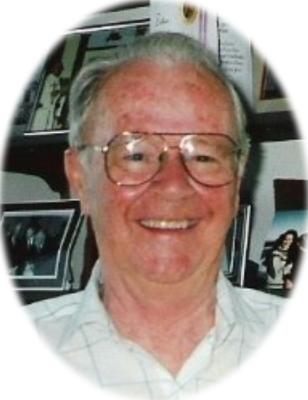 A smiling man with grey hair and aviator glasses.