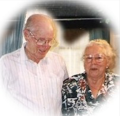 Harold and Wilda Clark A bald man standing next to a woman in a patterned shirt.