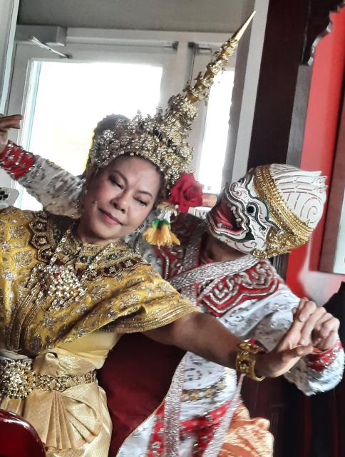 Members of Thai Dance Troupe of Ottawa. Two traditional Thai dancers in costumes, headdress, and mask.