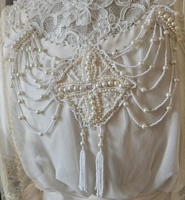 Replica wedding gown bodice Beading on the cream chiffon and lace bodice of Montgomery’s replica Edwardian wedding gown at her Birthplace in New London, Prince Edward Island.