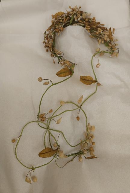 Orange blossom coronet Wax and wire orange-blossom coronet worn over Montgomery’s original tulle veil, with flower buds and leaves.
