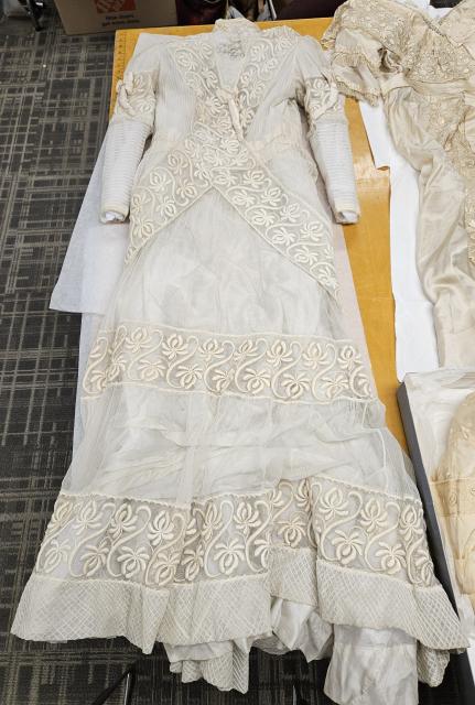 Sharp wedding gown Ivory silk, lace, and voile wedding gown decorated with fabric roses and crossed lace bands belonging to Eleanor (Sharp) Long, circa 1910.