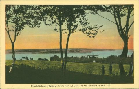 Cavert Figure 2 Front of a postcard depicting the Charlottetown harbour. Trees are in the foreground with fields and water in the background. The sky is pink.