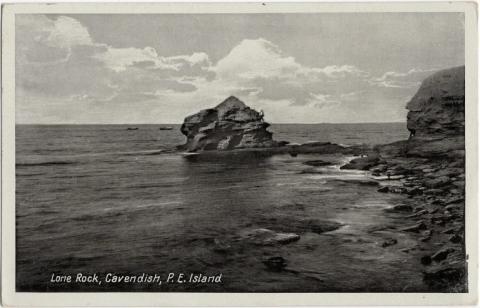 Cavert Figure 7 Black-and-white postcard depicting Lone Rock. In the centre of the image is a rock formation surrounded by water. On the right is a shore with many smaller rocks.