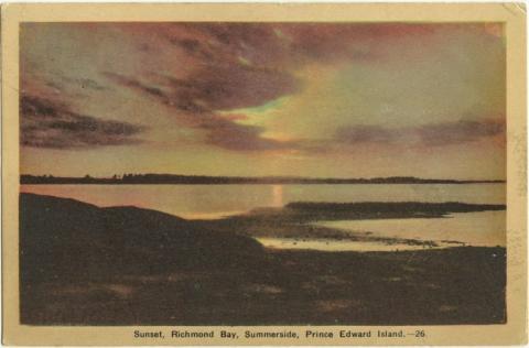 Postcard of a sunset at Richmond Bay. The sky is pink and purple and reflects off the still water below. 