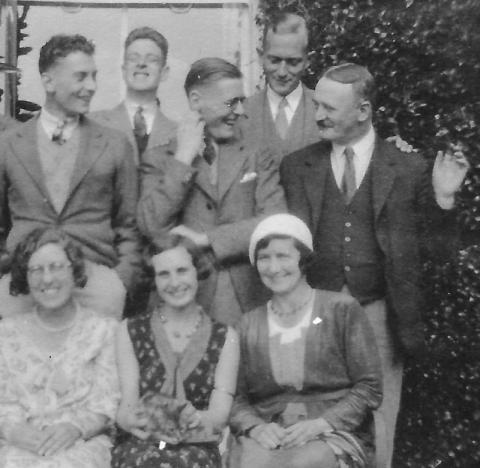 Black-and-white photograph of George MacMillan and seven friends. 