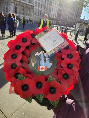 Andrea McKenzie The Canadian wreath of bright-red poppies. The photo at its centre shows Nursing Sisters Guilbride, McNichol, and Mowat in their light-blue working uniforms and white veils.