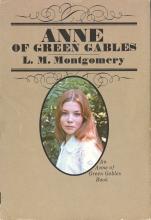 Book cover with title “Anne of Green Gables” and photograph of young woman with long red hair